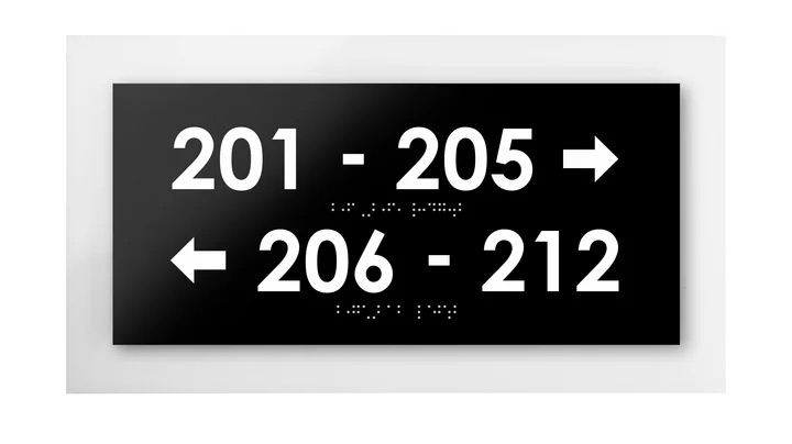 black acrylic directional sign with room numbers and braille